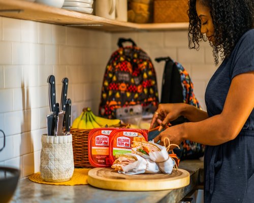 A person preparing a quick healthy breakfast in a colorful kitchen