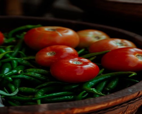 Fresh tomatoes, chilies, and vegetables displayed at a local Mexican market
